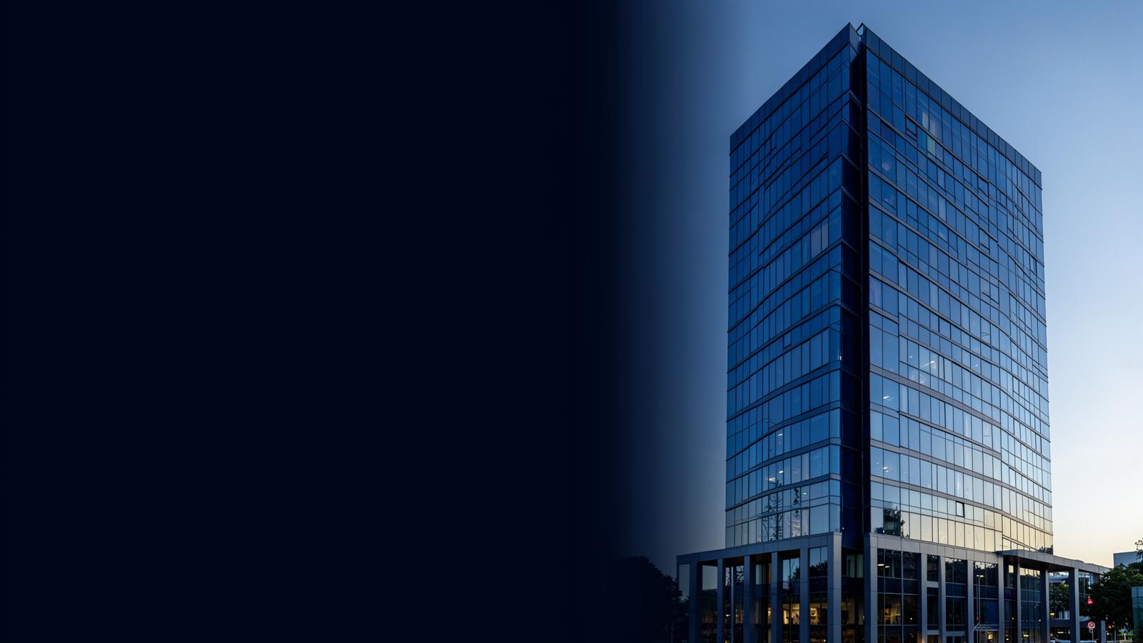 Modern commercial office tower in cool blue light